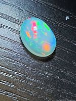 Top view of oval opal showing play-of-colour