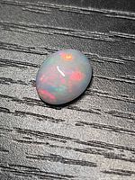 Top view of oval Ethiopian fire opal showing red, green and orange play-of-color