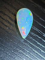 Top view showing pear cabochon and play of colour
