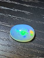 Front view of oval opal showing body tone and play of color