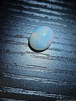 Top view of oval opal showing body colour and play of colour