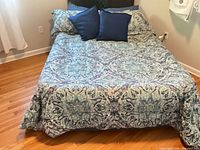 Bed showing queen paisley comforter, matching shams and pillows