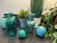 Group shot of turquoise vases, candle holder, candles, faux plants