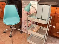 Chair, boxed cart, assembled cart with lamp and magazine holders