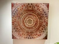 Front view of metallic mandala canvas art