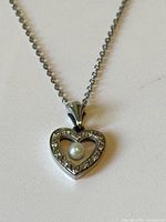 Necklace laid flat showing pendant and chain