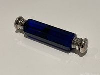 full view of cobalt blue double-ended scent bottle showing both metal caps