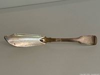 Full view of sterling silver butter knife showing blade and handle
