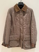 Full view of jacket front showing quilting, pockets, snaps