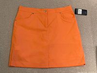 Full view of front of skort showing color, pockets, button, attached retail tag