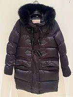 Full view of black Burberry Brit down parka with fur hood