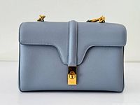 Front view of pastel blue Celine Teen Soft 16 bag showing flap and gold clasp