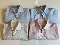 Four folded Stenströms shirts laid out showing patterns and colors