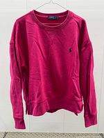 Front view of fuchsia crewneck sweatshirt with navy polo pony logo