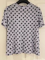 Full front view of lavender spotted Proenza Schouler T-shirt on hanger