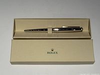 Pen in open Rolex presentation box