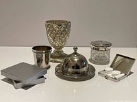 Group shot of all seven silver-tone and glass pieces