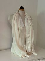 Full view of scarf draped on mannequin showing length and material