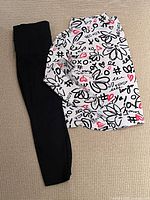 Top and leggings laid flat displaying full items