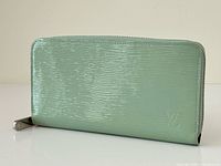 Front view of mint green Louis Vuitton Electric Epi leather zip-around wallet
