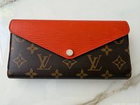 Front view showing orange epi leather flap and LV monogram canvas