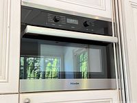 Front view of Miele built-in microwave convection oven installed in cabinetry
