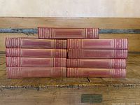 Front view of all nine encyclopedia volumes stacked showing spines