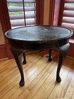 Full view of round tray table showing legs and overall form