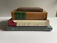 Stack of four books showing spines and covers