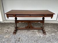 Front view of entire wooden console table showing legs and stretcher