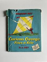Front of book with dust jacket showing title and kite image