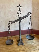 Full view of balance scale showing stand, crossbeam, chains and pans