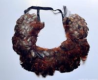 Full view of feather collar showing overall shape and ribbon ties