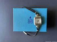 Front view of Eterna Challenger watch on blue Birks box