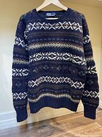 Front view of patterned wool sweater hanging