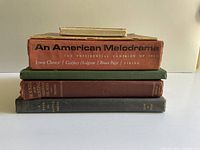 Stack of four titles showing spines including An American Melodrama and Hounds and Hunting