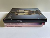Stacked view of the three books showing spines and cover edges