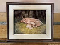 Front view of framed painting depicting sow and piglets