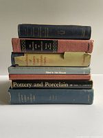 Stack of 8 pottery and porcelain reference books showing spines and condition