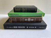 Stack of four reference books showing spines and sizes