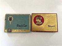 Front view of both cigarette tins closed