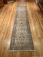 Full view of the long handmade runner rug on hardwood floor
