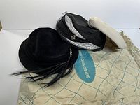 Overview of all three hats and paper bag