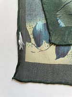 Close-up of corner showing tear in fabric and rolled hem