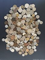 Full pile of assorted coins spread on surface