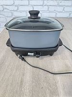 Full view of electric skillet showing pan, base, lid and cord