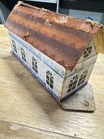side view of painted wooden ark showing roof wear