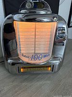 Front view of Crosley tabletop jukebox showing illuminated selector cards and cassette slot