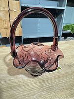 Full view purple amethyst glass basket with applied handle and ruffled rim