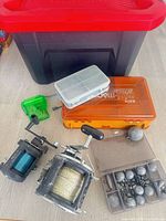 Overall lot showing reels, tackle boxes, weights, Craftsman tote